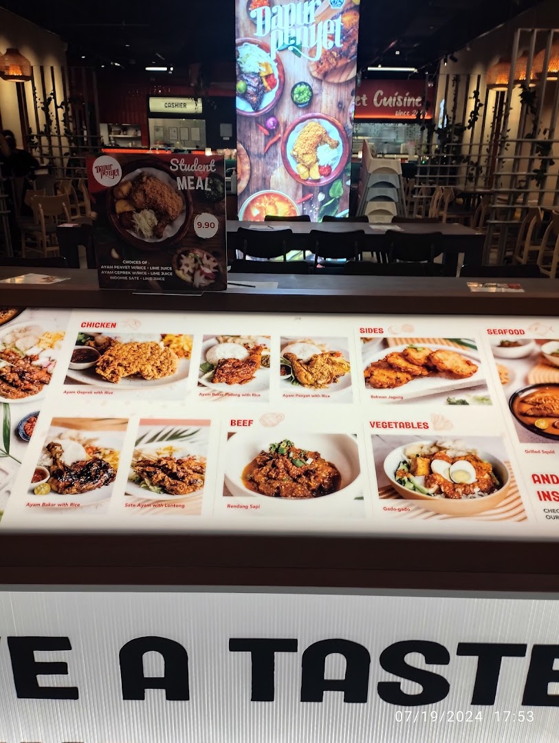 A vibrant menu display board showcasing various Indonesian dishes and a special student meal offer.
