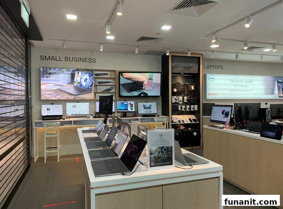 Interior view of a Dell Exclusive Store showcasing laptops, accessories, and display screens.