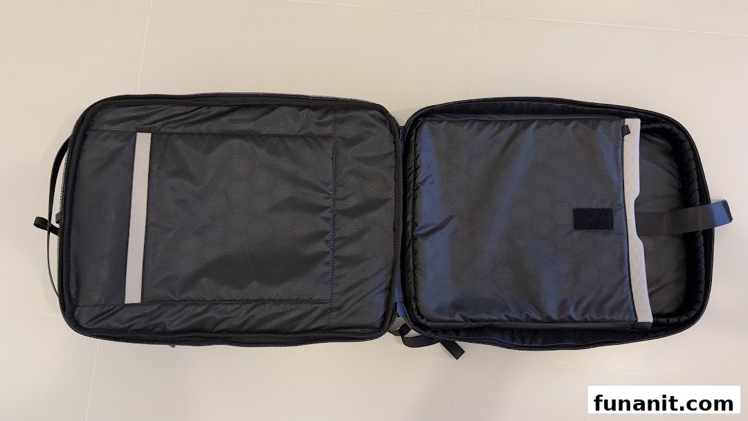 An open black laptop bag or case, revealing its padded interior compartments and organizational features.