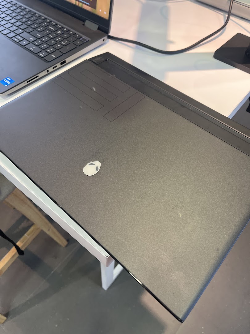 A close-up view of a black Alienware gaming laptop on display at Dell Exclusive Store.