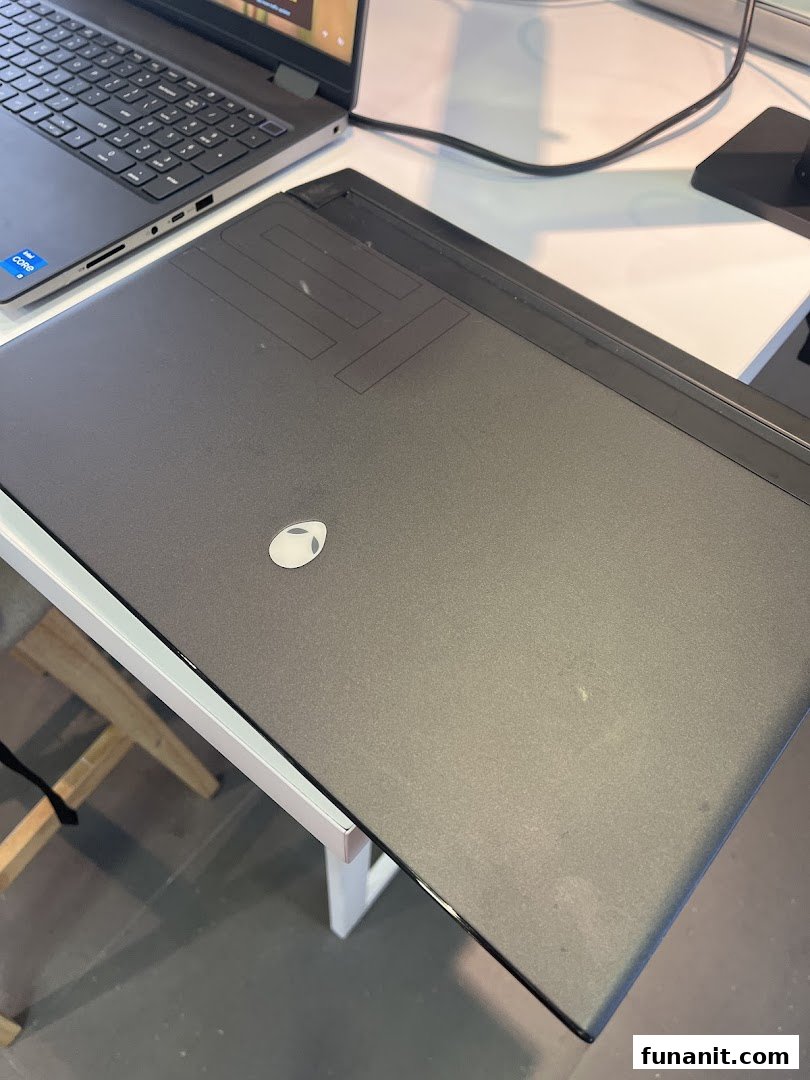 A close-up view of a black Alienware gaming laptop on display at Dell Exclusive Store.