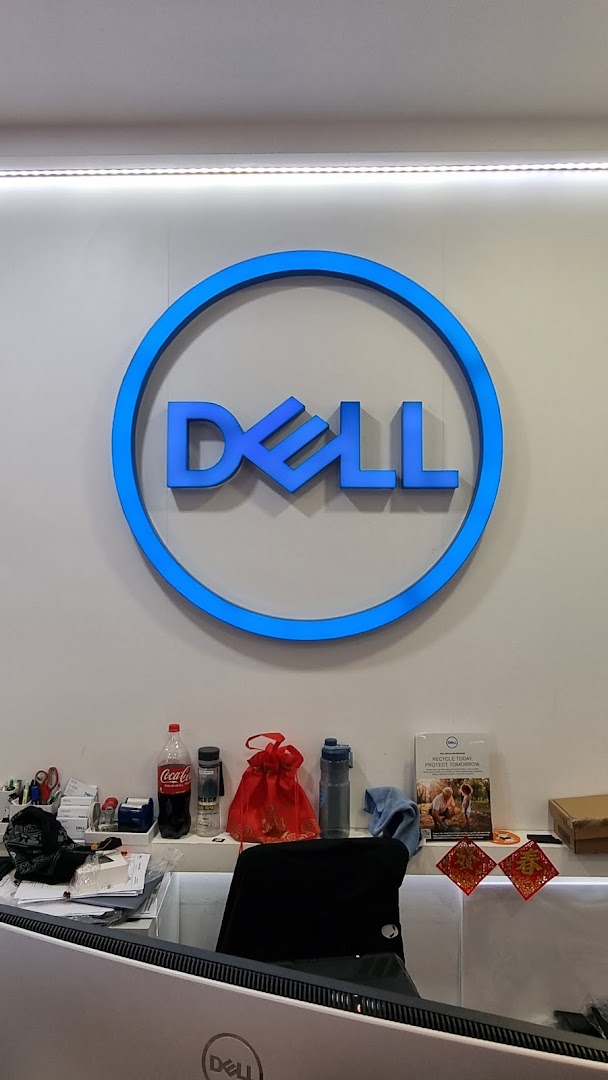 A prominent blue Dell logo illuminates a clean counter area inside the Dell Exclusive Store.