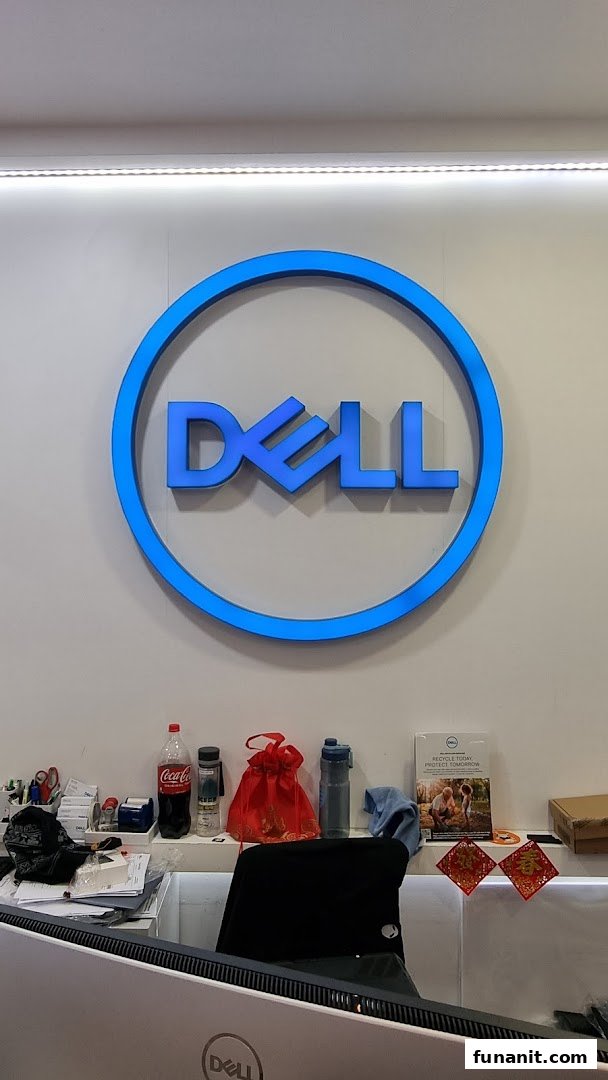 A prominent blue Dell logo illuminates a clean counter area inside the Dell Exclusive Store.