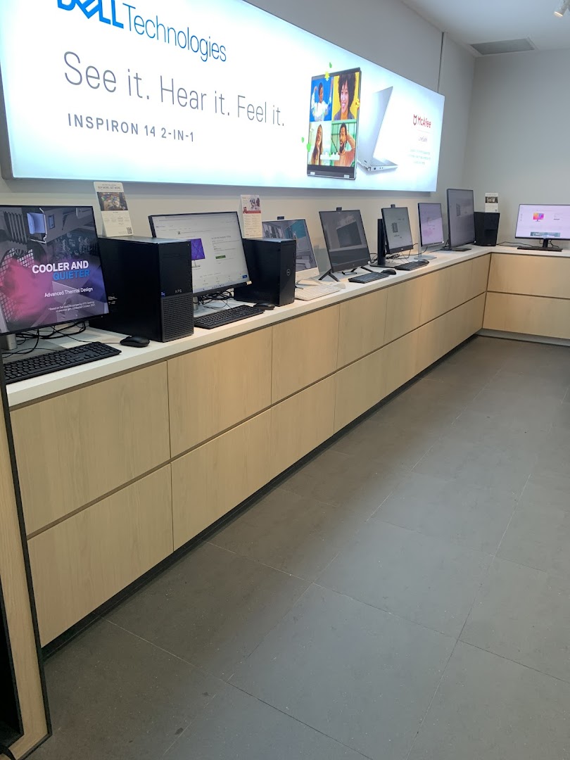 An interior view of the Dell Exclusive Store showcasing various desktop computers and laptops on display.