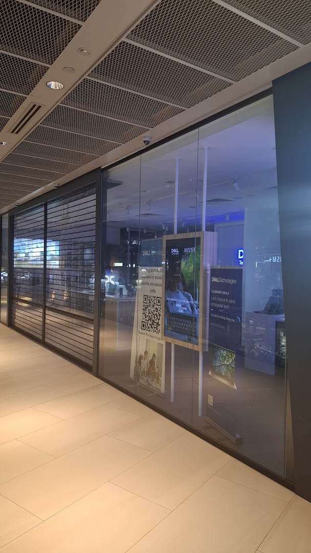 The exterior of a Dell Exclusive Store with glass windows and promotional displays.