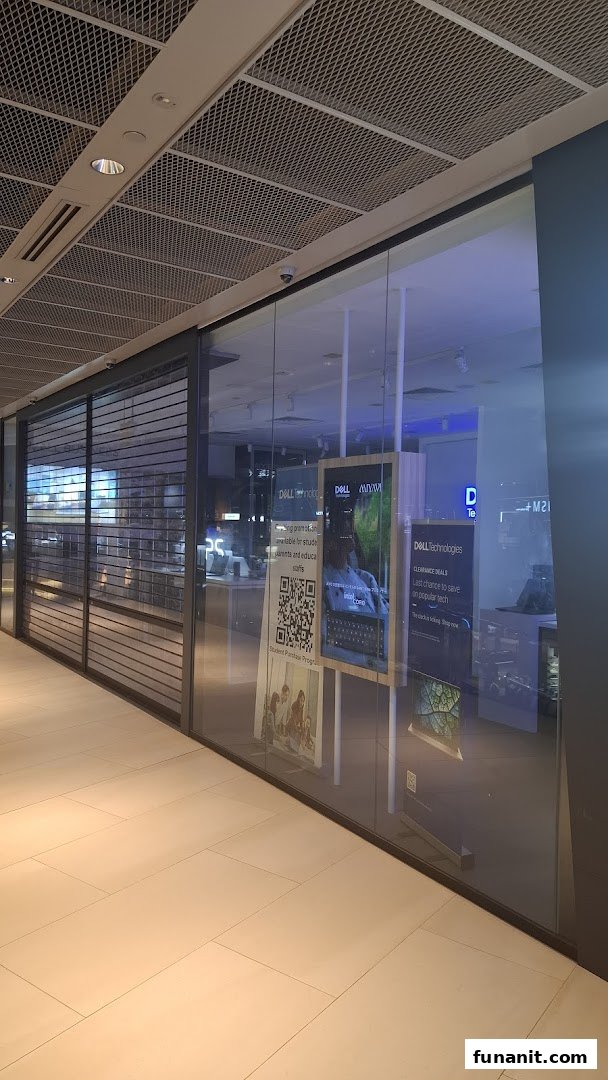 The exterior of a Dell Exclusive Store with glass windows and promotional displays.