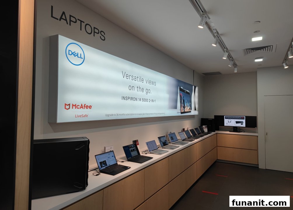 Interior view of a Dell Exclusive Store showcasing various laptops and a large promotional display.