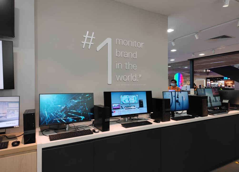Interior view of Dell Exclusive Store showcasing multiple desktop computers and monitors on display.