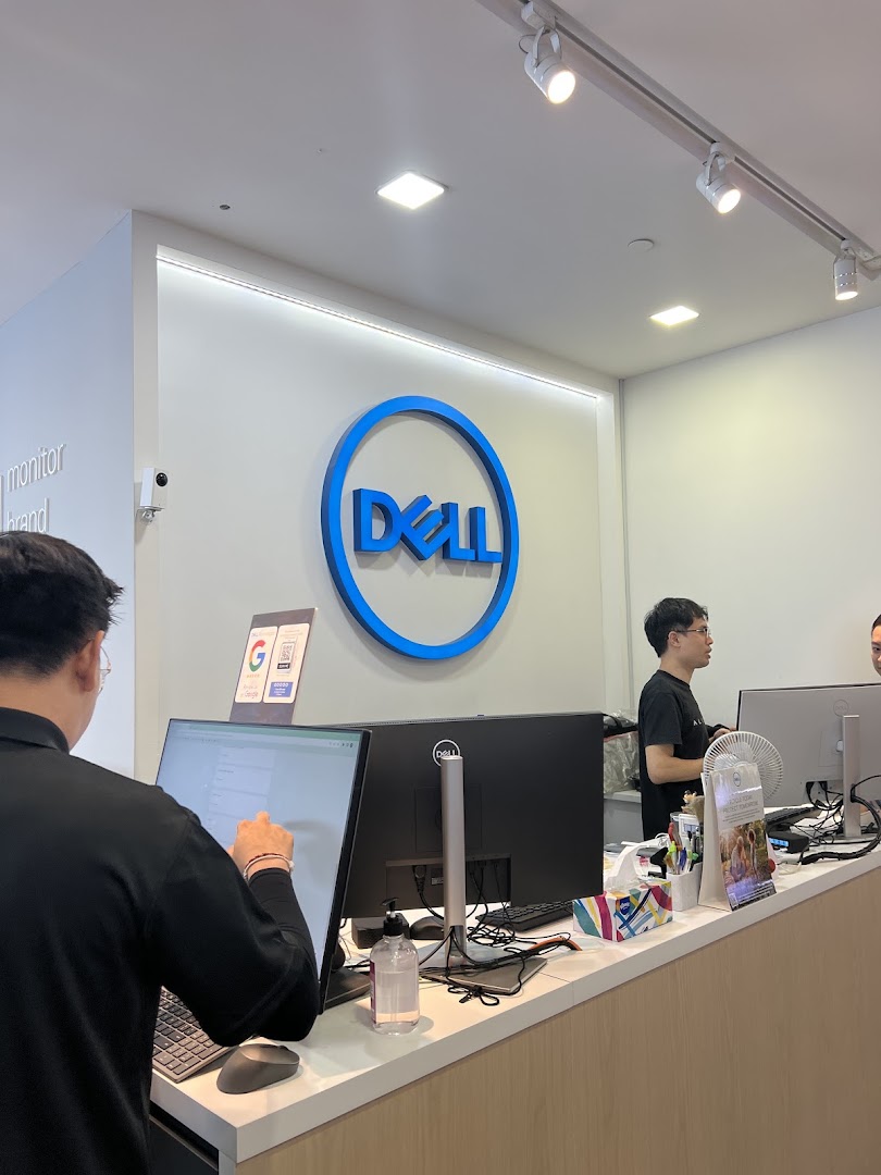 Interior view of a Dell Exclusive Store, featuring the brand logo and staff assisting customers at the counter.