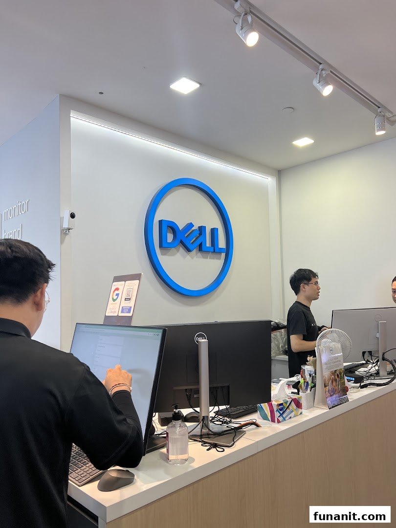 Interior view of a Dell Exclusive Store, featuring the brand logo and staff assisting customers at the counter.