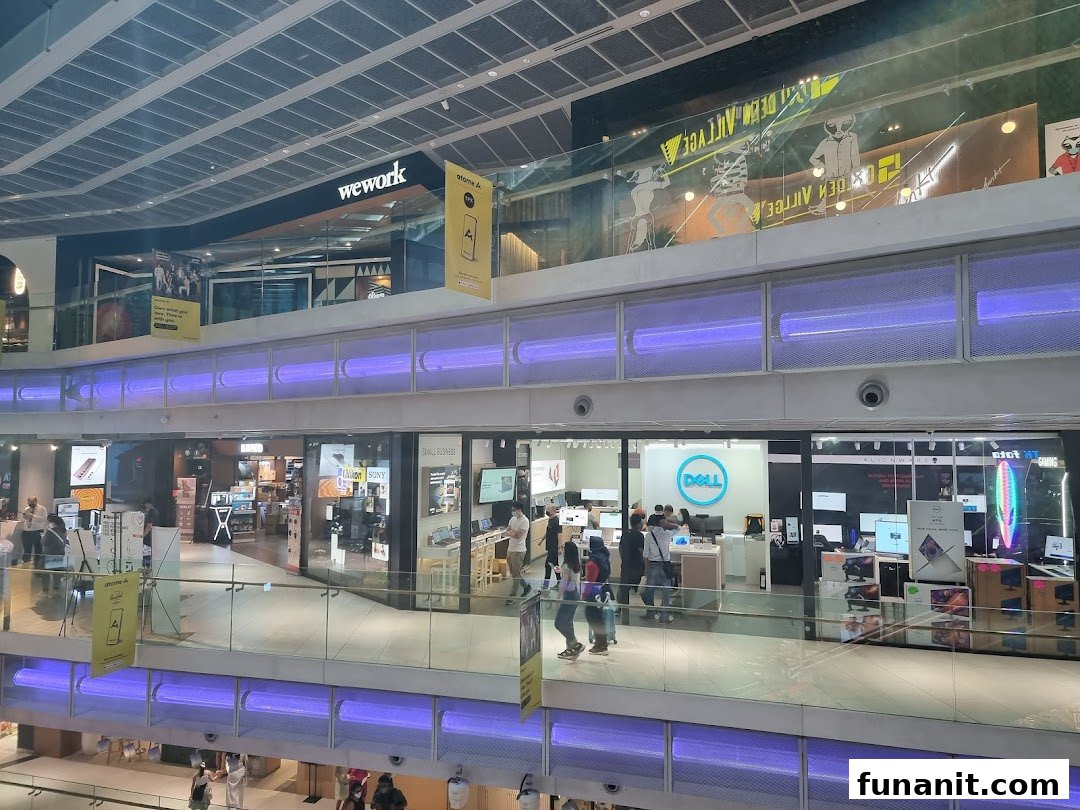 View of Dell Exclusive Store Funan from across a mall walkway, showcasing its entrance and products.