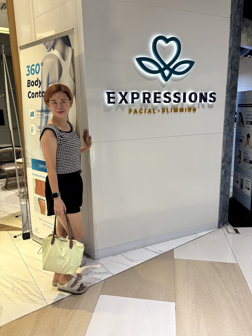 A woman stands by the entrance of Expressions Facial & Slimming, showcasing its prominent signage.