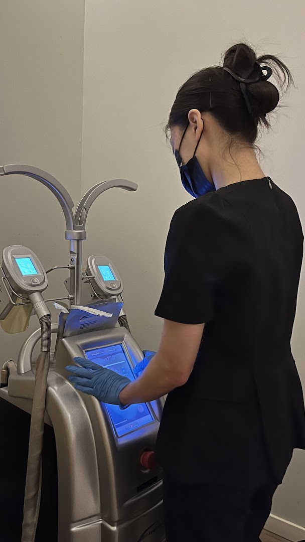A staff member operates advanced slimming equipment at Expressions Funan.