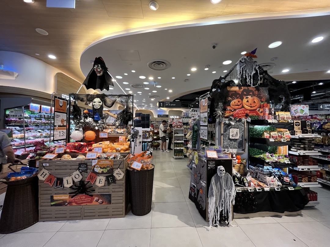 FairPrice Finest Funan Mall interior featuring festive Halloween decorations and product displays.