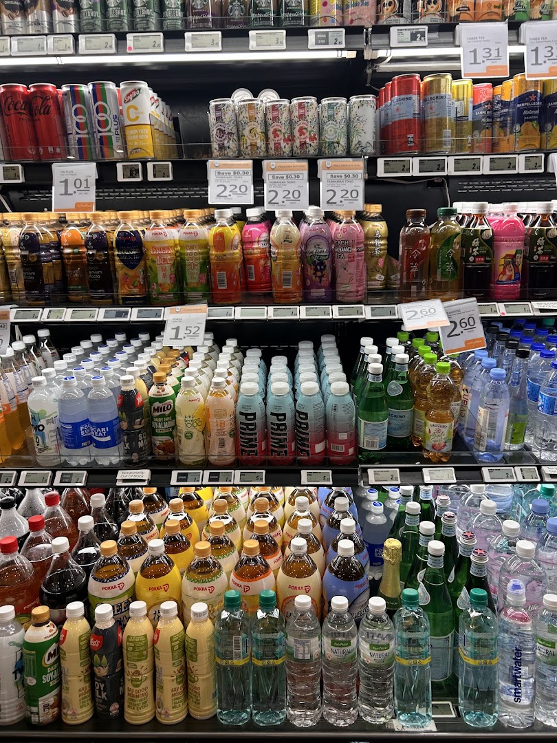 A well-stocked supermarket aisle displaying a wide variety of bottled and canned beverages.