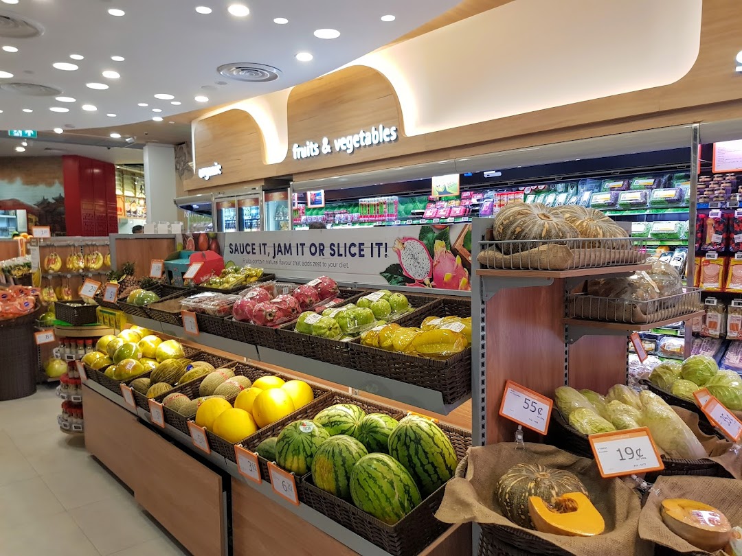 A vibrant display of fresh fruits and vegetables in the produce section of FairPrice Finest.