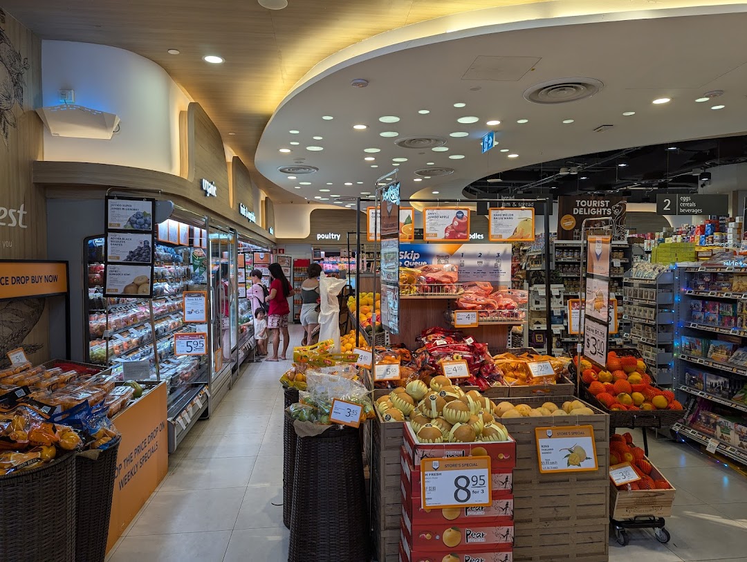 Interior view of FairPrice Finest supermarket, showcasing fresh produce, packaged goods, and a wide selection of groceries.