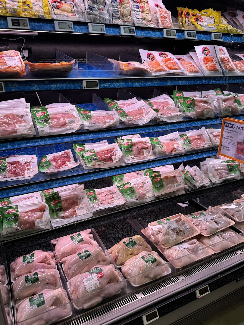 A well-stocked refrigerated display of fresh packaged meats, poultry, and seafood at FairPrice Finest.