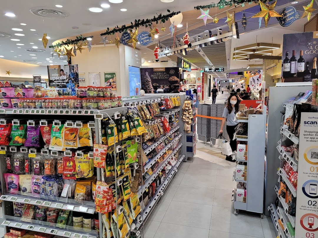 An aisle inside FairPrice Finest Funan Mall, featuring diverse packaged goods and festive decorations.