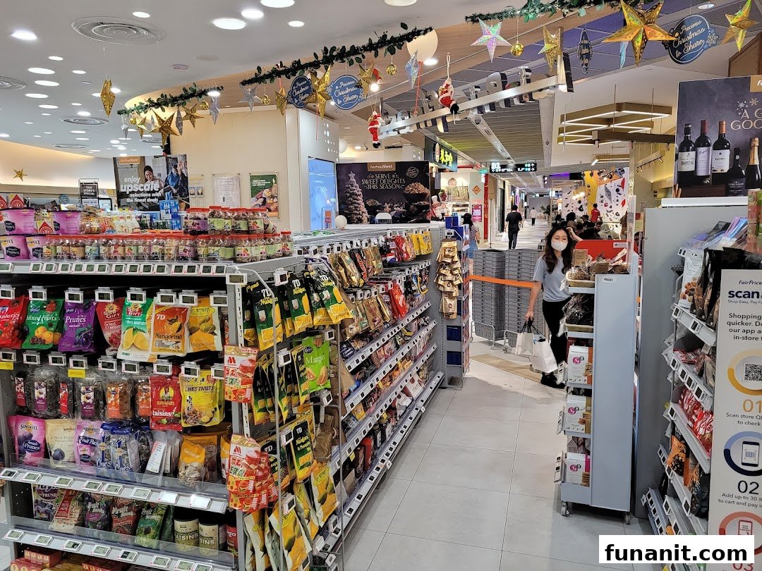An aisle inside FairPrice Finest Funan Mall, featuring diverse packaged goods and festive decorations.