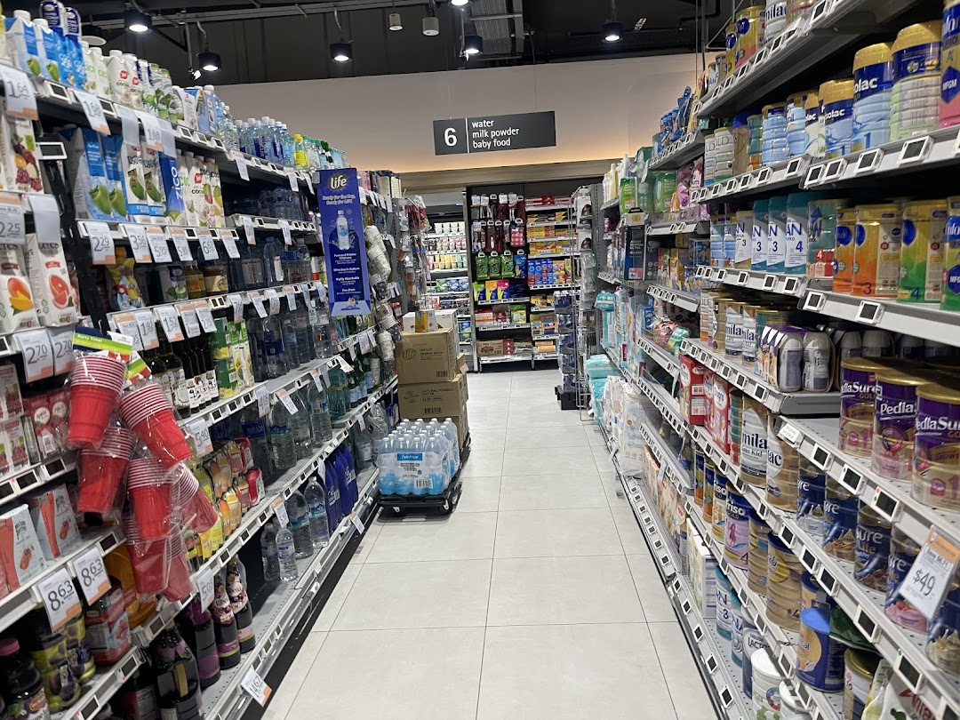 A well-stocked aisle at FairPrice Finest Funan Mall, featuring beverages, baby food, and milk powder.