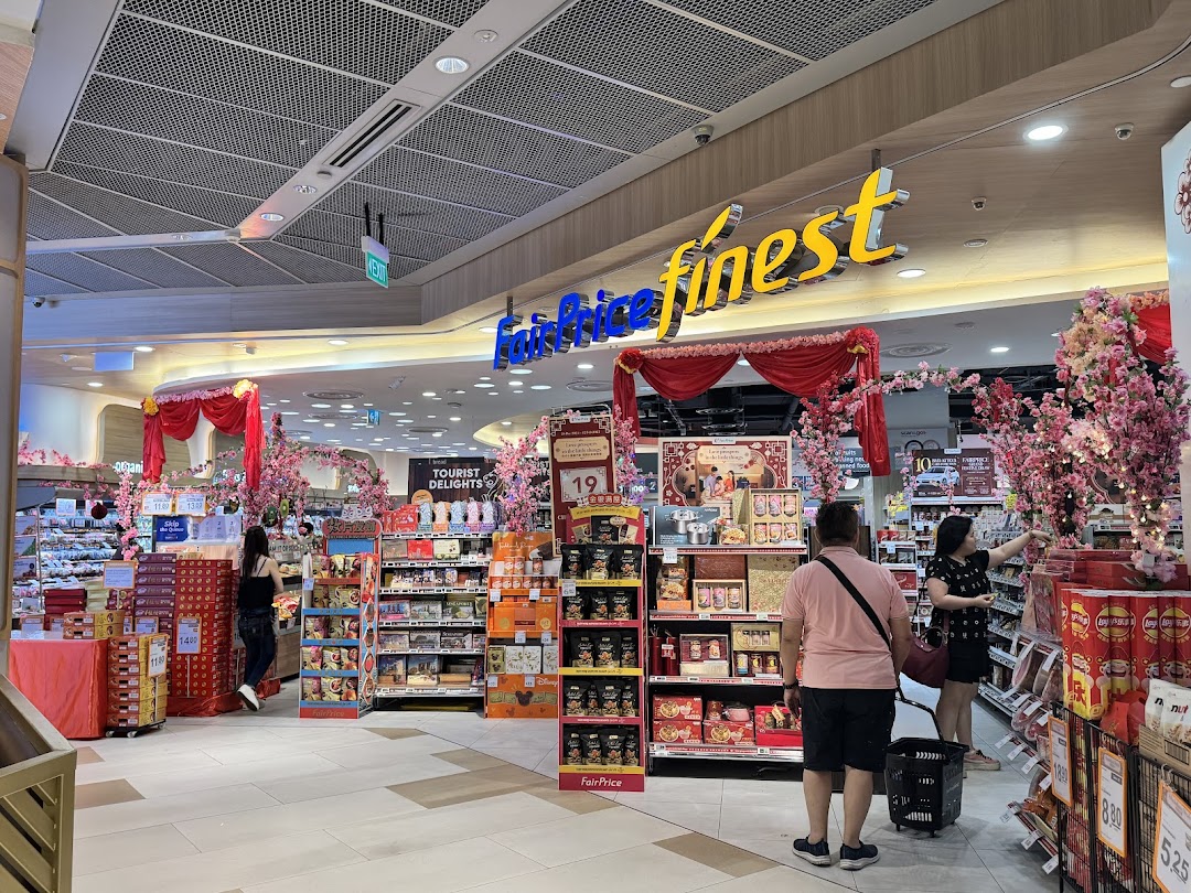 Interior of FairPrice Finest supermarket, featuring festive decorations and customers browsing products.