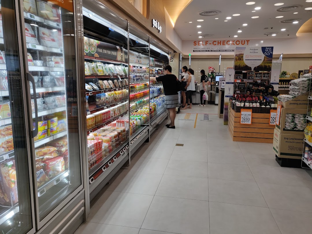 Interior view of FairPrice Finest supermarket, showcasing refrigerated aisles and a self-checkout area.