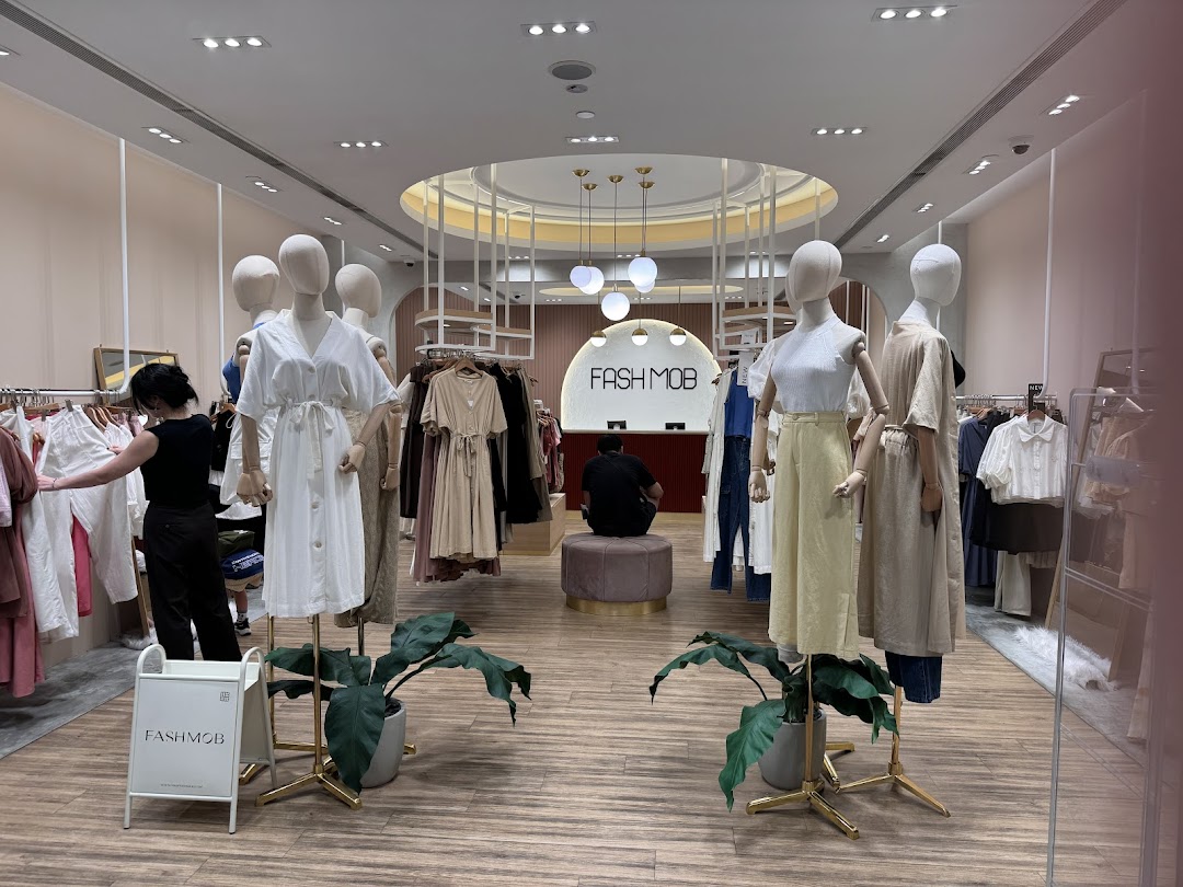 Interior view of Fash Mob boutique showcasing stylish women's apparel on mannequins and racks.