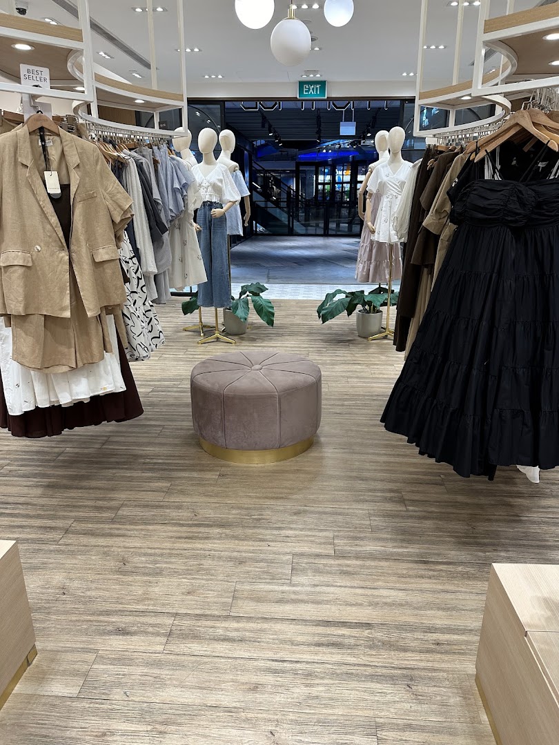 Interior view of Fash Mob boutique showcasing stylish women's apparel on mannequins and racks.