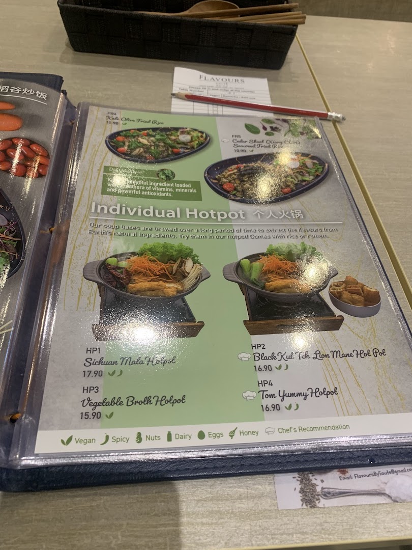 A close-up view of a menu from Flavours by Saute, showcasing various hotpot and fried rice dishes with prices and dietary icons.
