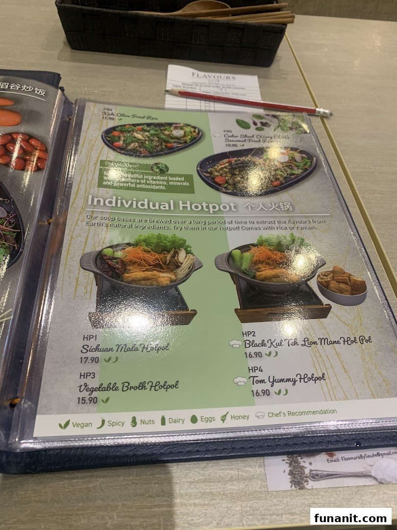 A close-up view of a menu from Flavours by Saute, showcasing various hotpot and fried rice dishes with prices and dietary icons.