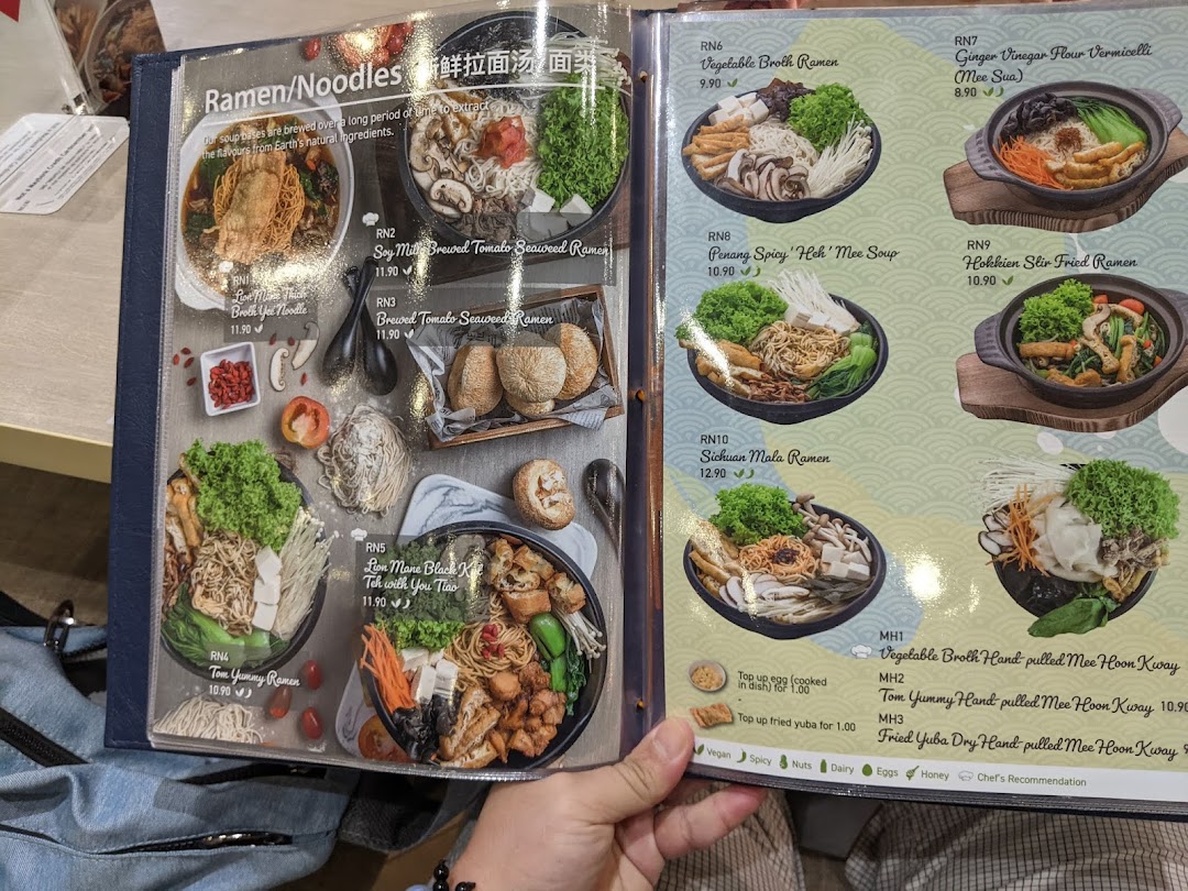 A close-up view of a menu page displaying various vegetarian and vegan ramen and noodle dishes.