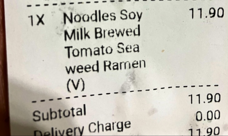 A close-up of a receipt or order screen showing a vegan ramen dish and its price.