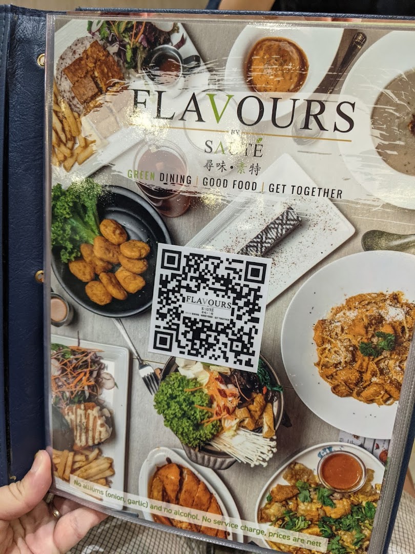 A vibrant menu cover from Flavours by Saute showcasing diverse vegetarian and vegan fusion dishes.