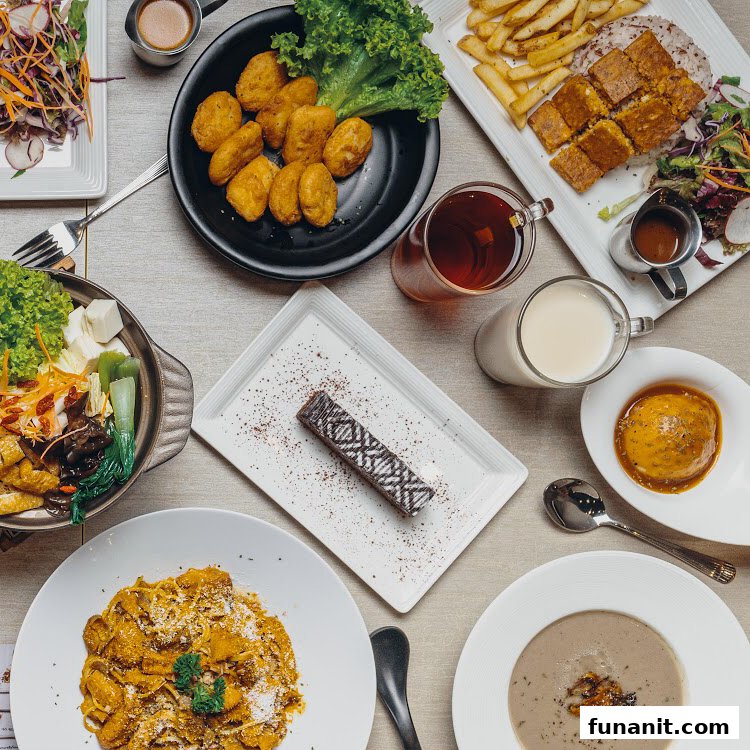 An overhead view of a table laden with a variety of delicious vegetarian and vegan dishes, drinks, and desserts.