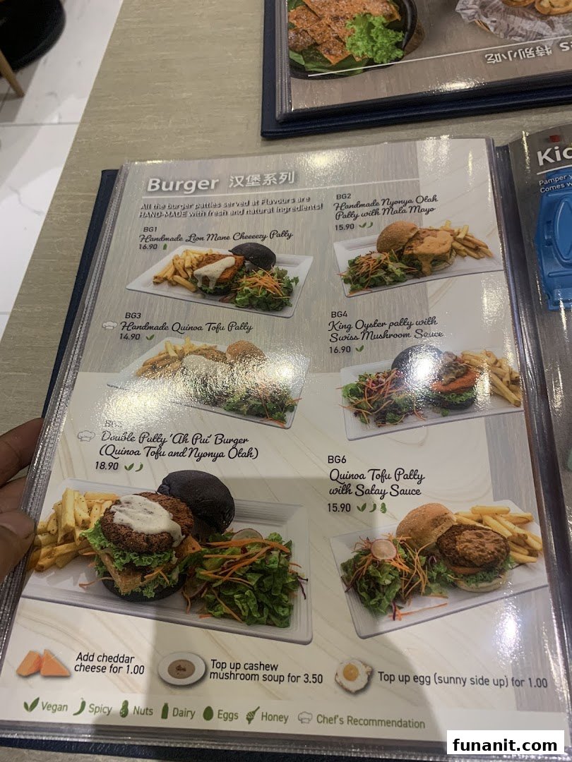 A menu page from Flavours by Saute, showcasing a variety of handmade vegetarian and vegan burgers.