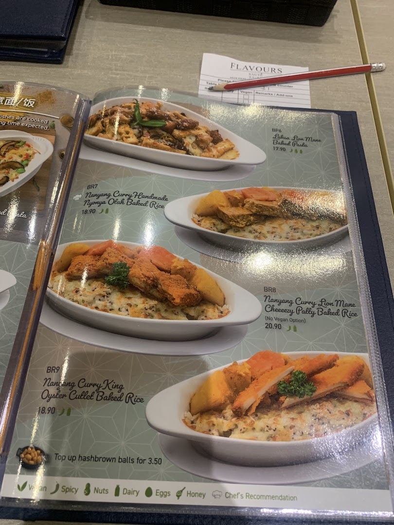 A close-up view of a menu displaying various baked rice and pasta dishes with prices and dietary information.