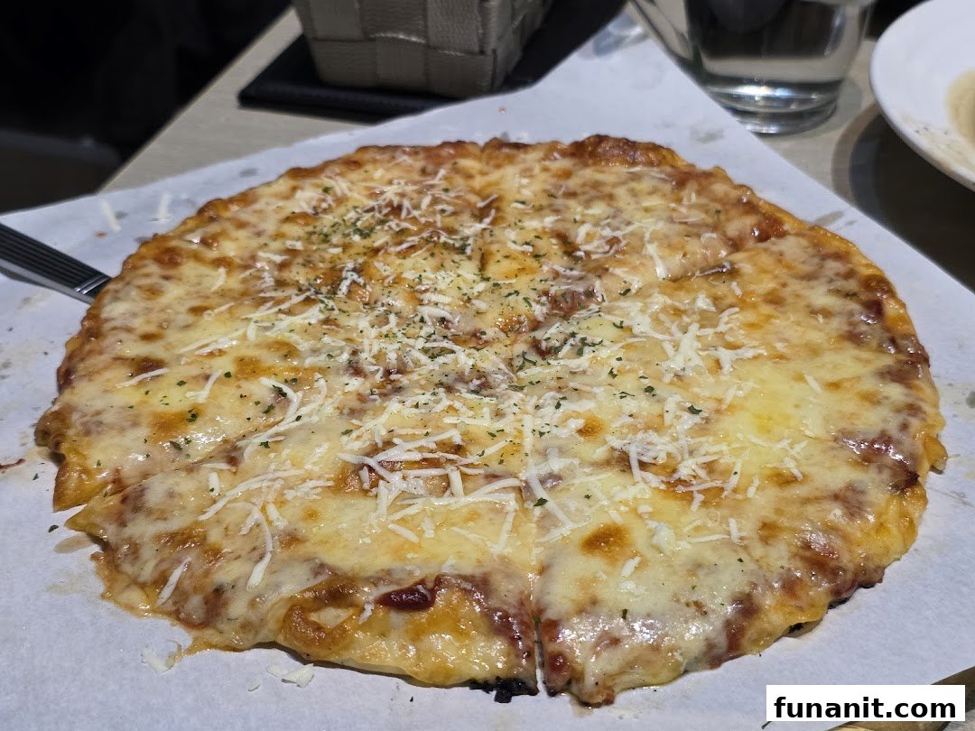 A freshly baked, cheesy pizza topped with herbs, served on parchment paper.