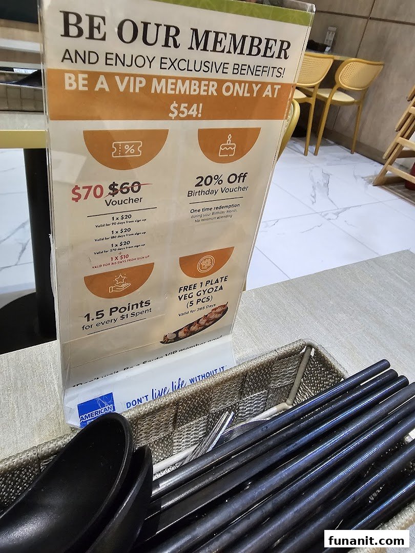 A close-up of a membership benefits standee on a dining table, featuring exclusive offers.