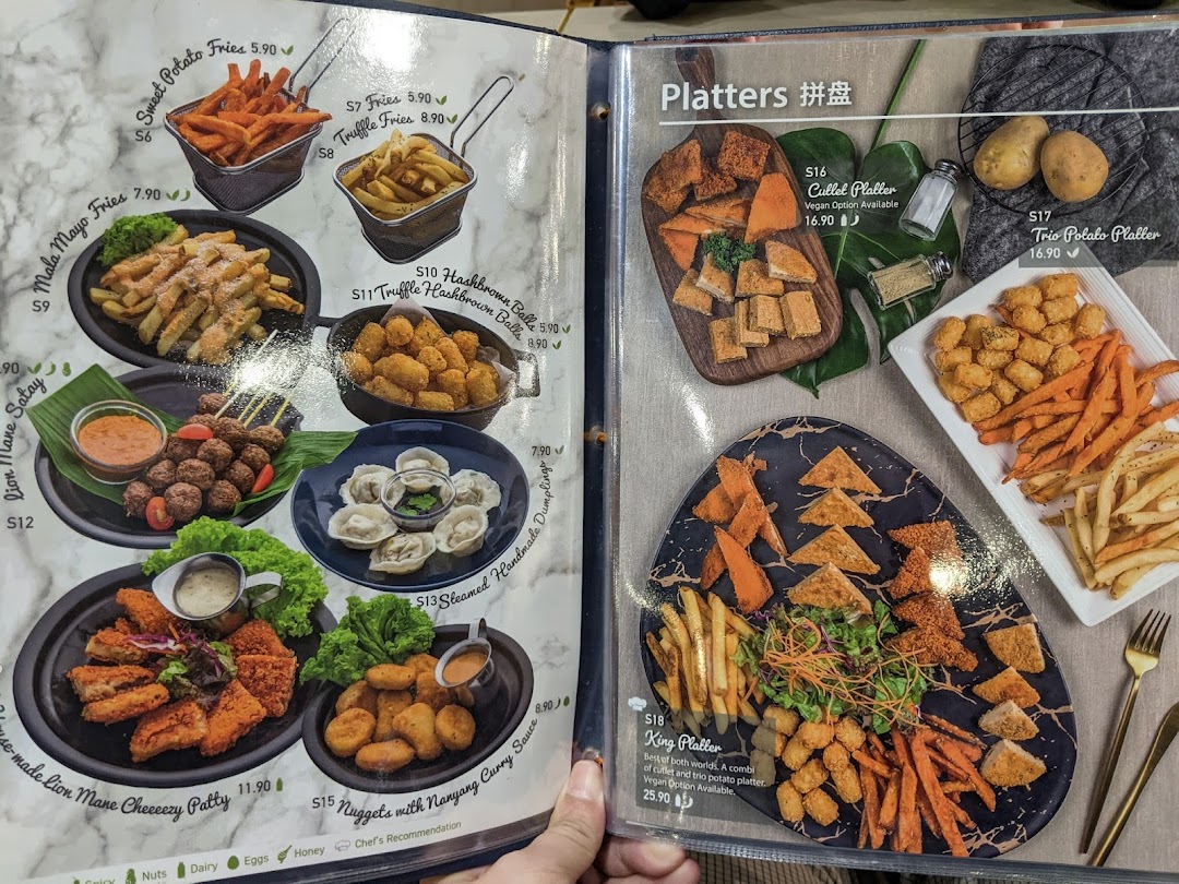 The image displays a variety of vegetarian and vegan dishes, including fries, hashbrowns, dumplings, and platters, from the restaurant's menu.