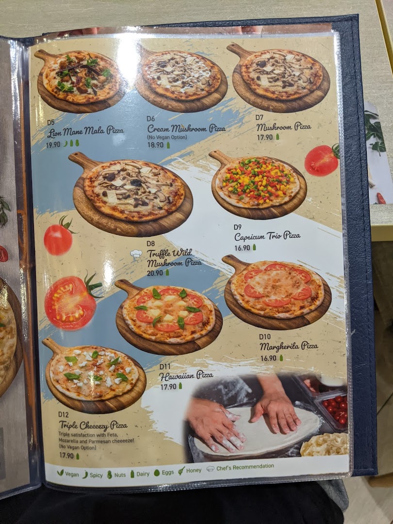 A vibrant menu page showcasing a variety of delicious vegetarian and vegan pizza options with prices.