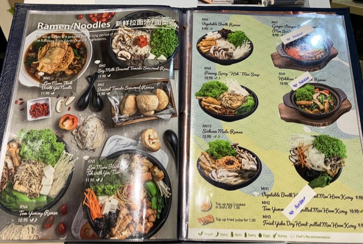 A detailed menu page showcasing various ramen and noodle dishes with prices and images.