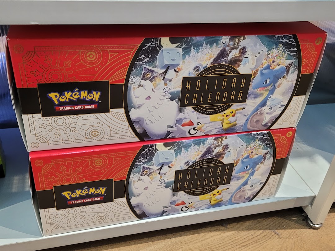 Two Pokémon Trading Card Game Holiday Calendars are displayed on a shelf, featuring festive Pokémon characters.