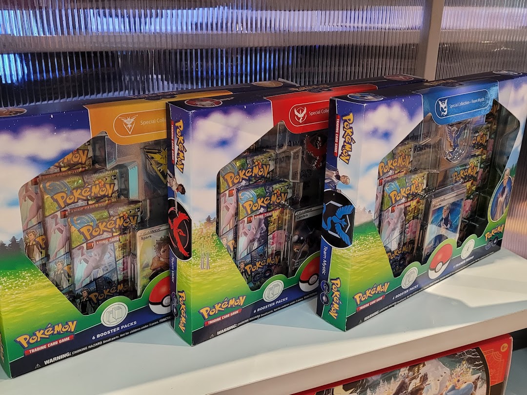 Three Pokémon Trading Card Game special collection boxes displayed on a shelf.