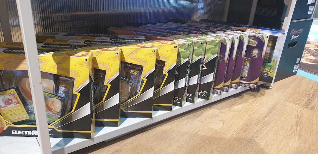 A shelf displaying various Pokémon Trading Card Game V Box sets, including Electrode V and Palkia VSTAR.