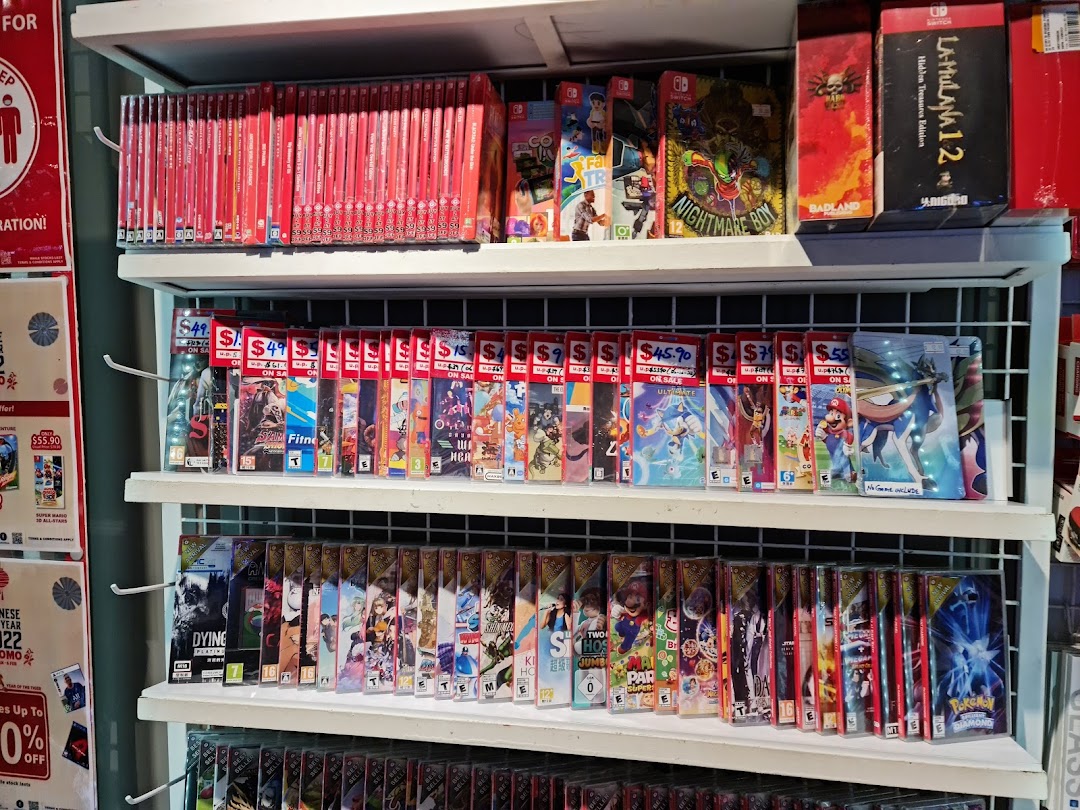 Shelves filled with numerous Nintendo Switch game titles and cases, some with sale prices.