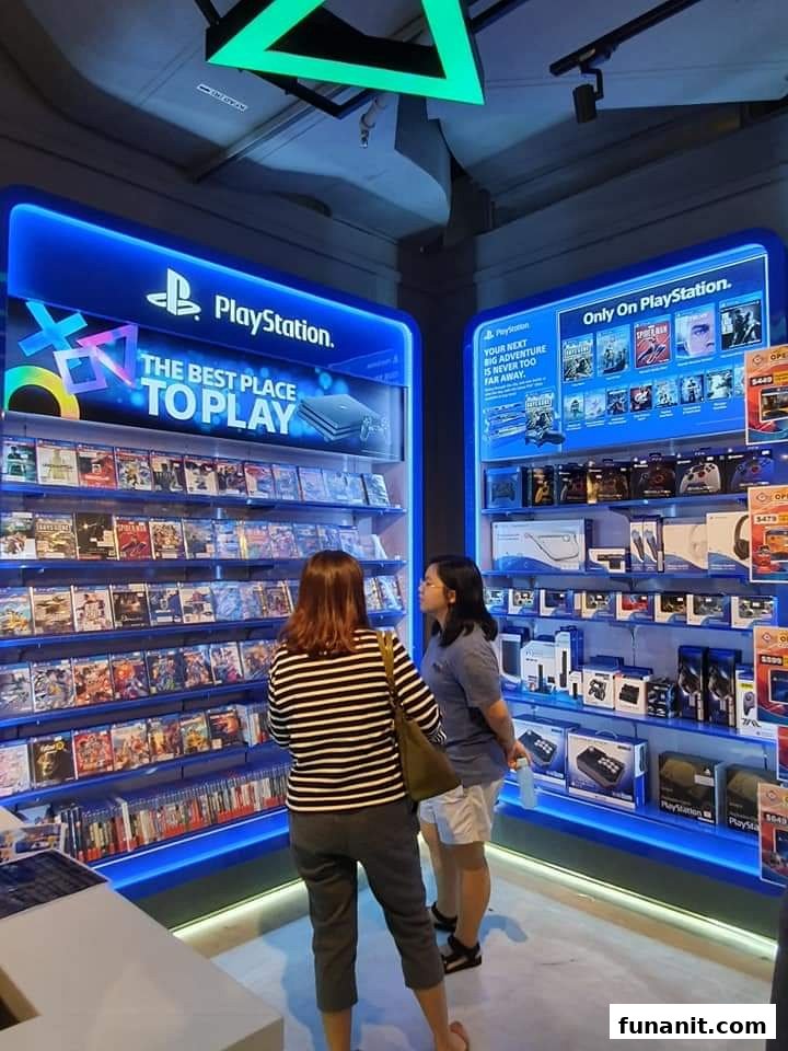 Two customers browse PlayStation games and accessories in a brightly lit display at GameMartz.