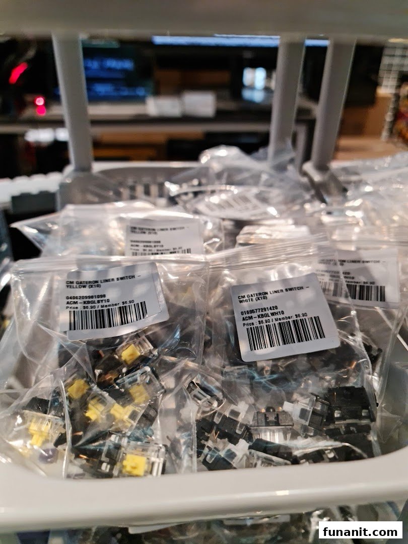 Close-up of bagged Gateron mechanical keyboard switches in yellow and white, displayed for sale.