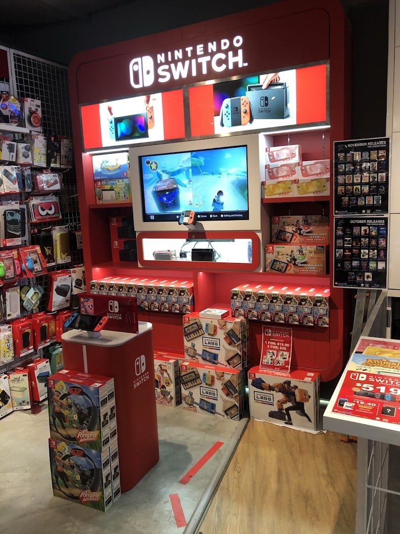 A vibrant Nintendo Switch display featuring consoles, games, and accessories within a retail store.