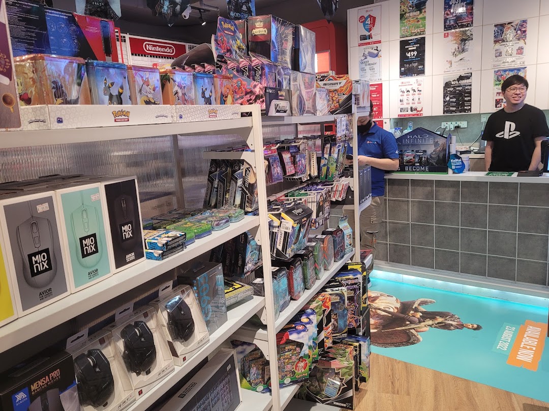 Interior view of GameMartz Funan Mall, showcasing shelves filled with gaming accessories, trading cards, and staff at the counter.